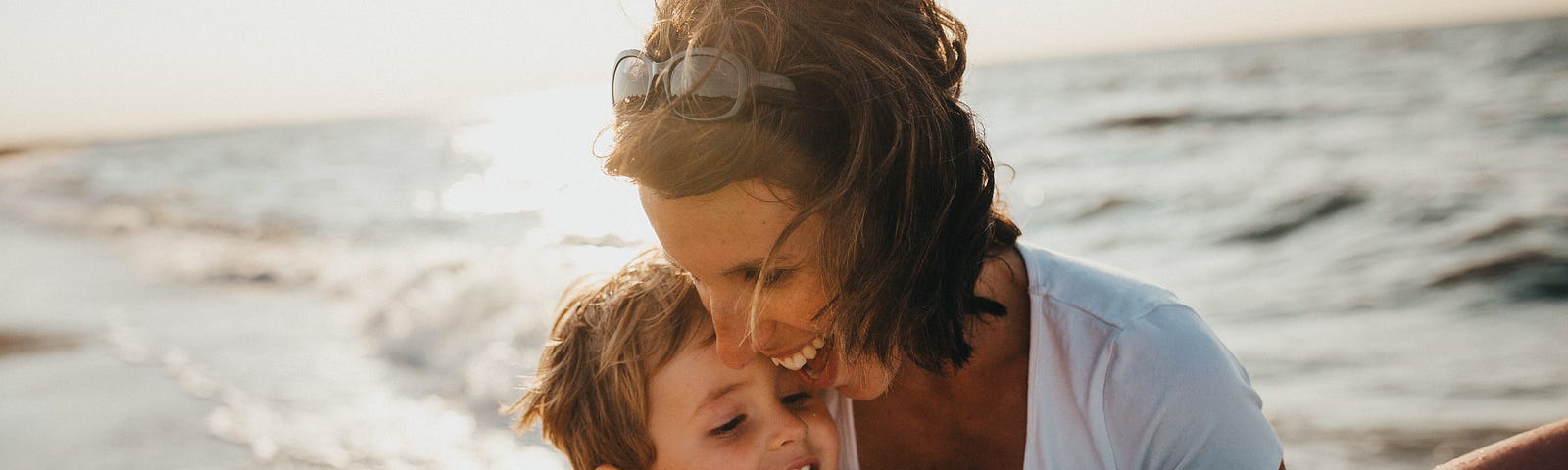 A mom holding her son on the beach. Main image for My blueprint for making 50K online this year with sustainable content creation.