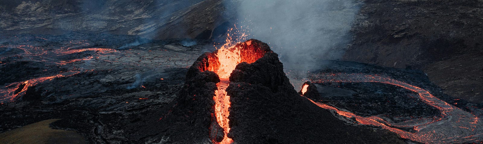 volcano opening with lava flowing out