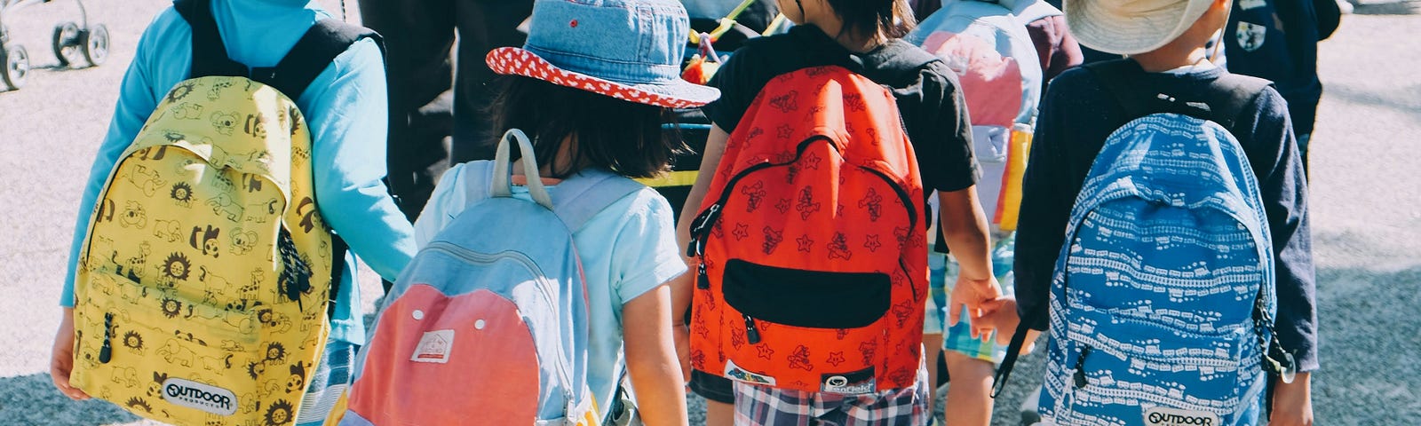 School children wearing hats and backpacks.