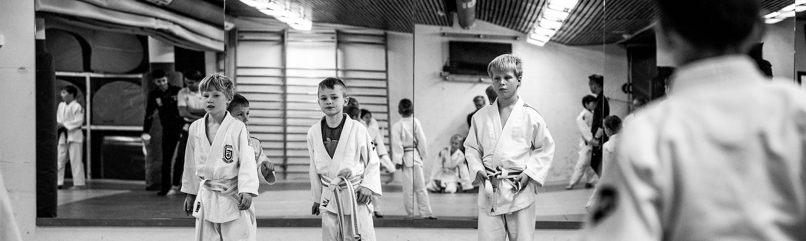 Photo of three boys getting ready for a karate competition via Alt text on Medium