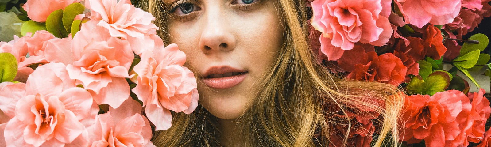 young woman looking unhappy surrounded by flowers