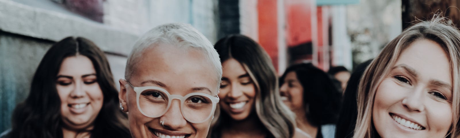 women embracing and walking down the street