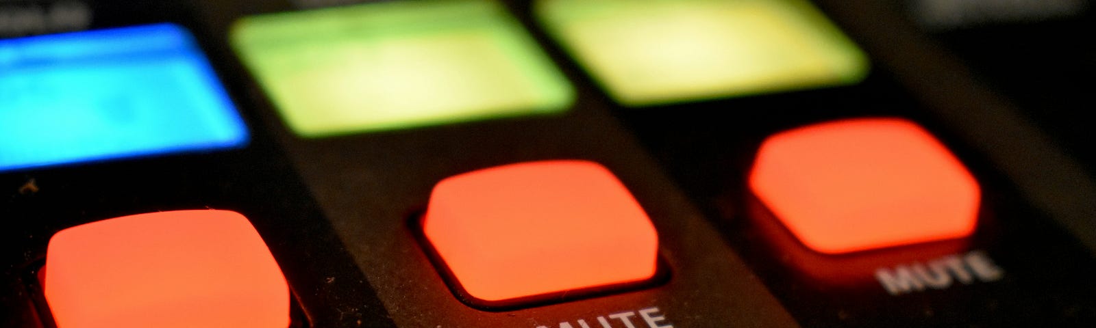 Three lit-up red buttons each labelled “mute” on black equipment