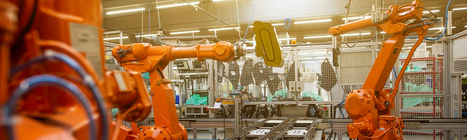 Industrial robots in a modern factory automate production processes, illustrating the combination of AI and RPA for enhanced efficiency, accuracy, and insights in 2024