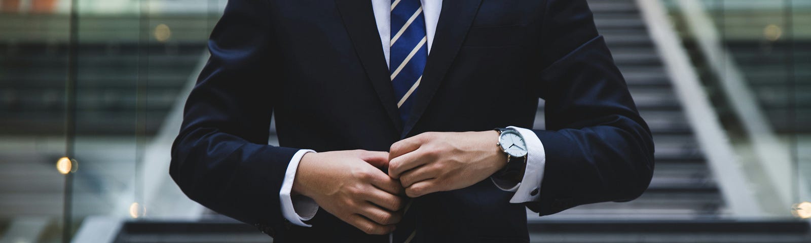 A close up of a suit jacket shirt and tie
