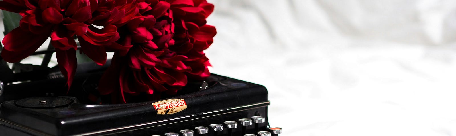 antique typewriter with flowers on top