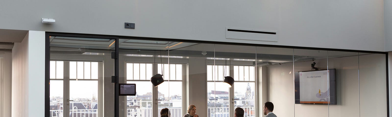 A modern office scene with workers round a table