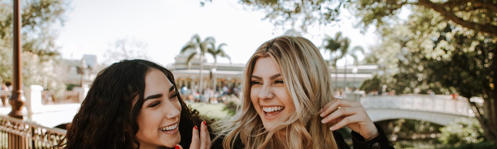 This photo shows two women laughing together.