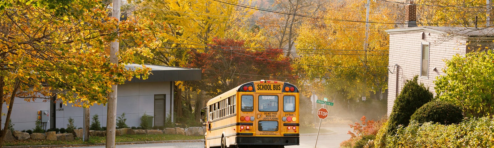 A school bus drives down a street.