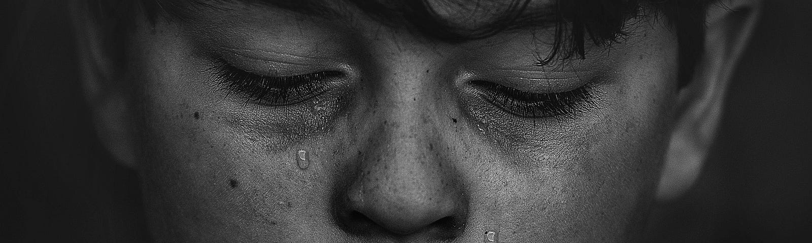 Black and white photo of boy crying. Death. Nobles.