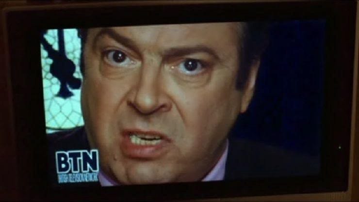 Lewis Prothero, a Trump-resembling character from V for Vendetta, speaks on a television channel from the film called BTN.