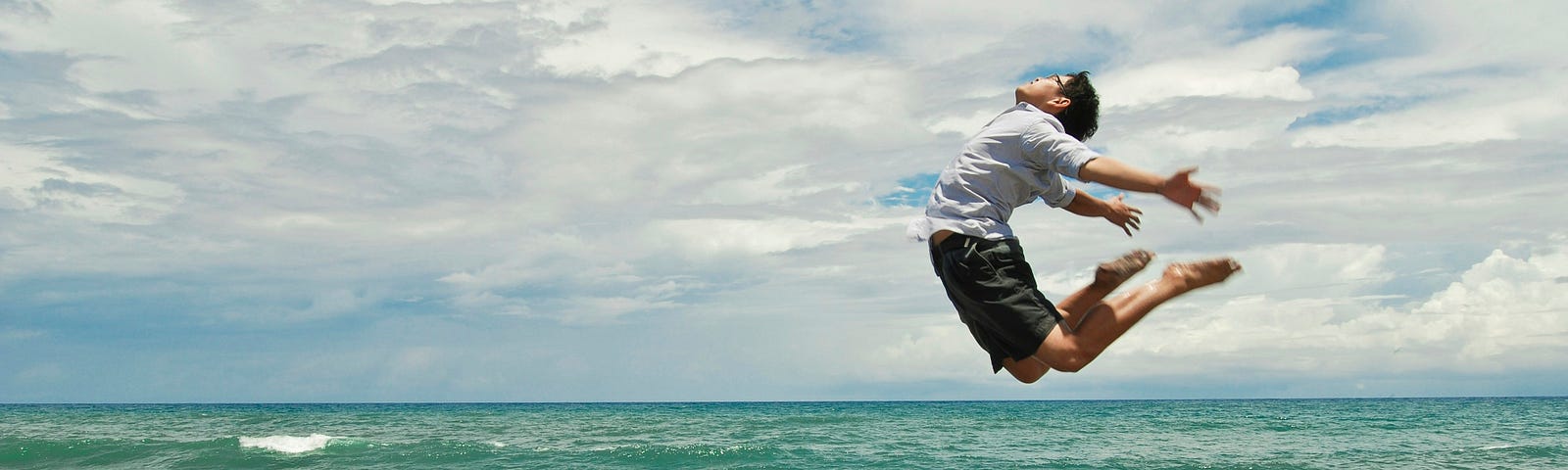 A man is photographed while he has jumped mid air.