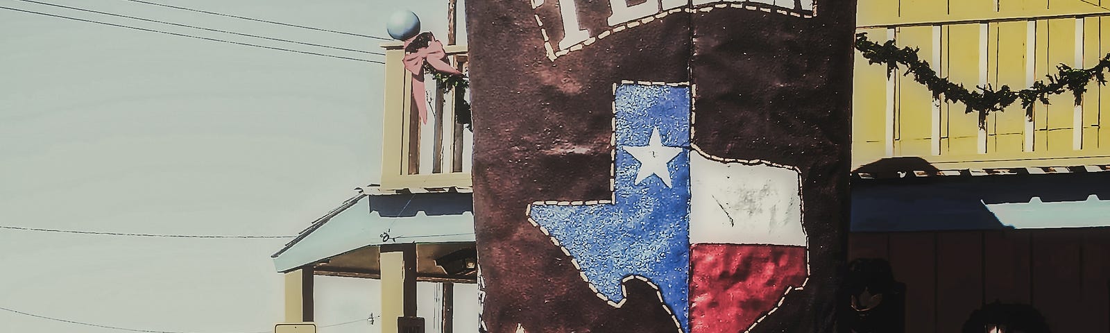 Enormous “Big Texan” cowboy boot embellished with the Texas Flag inside the shape of Texas