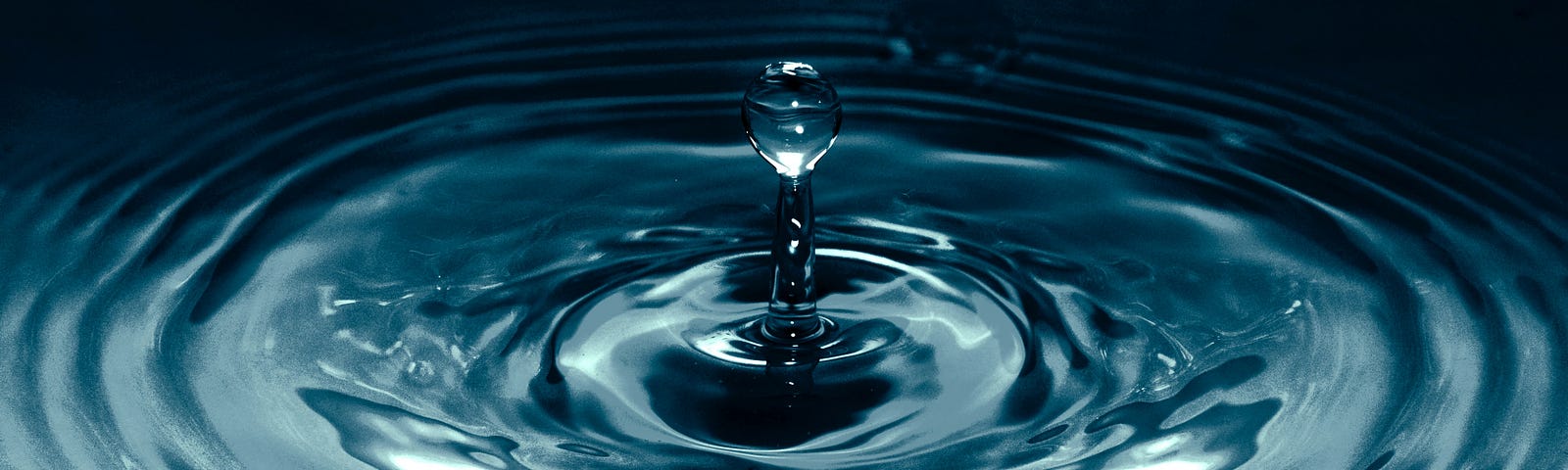 A drop of water causing a ripple effect.