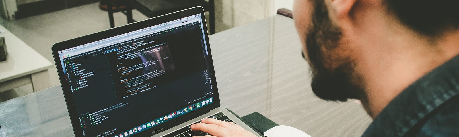 Computer engineer coding on a Macbook Pro