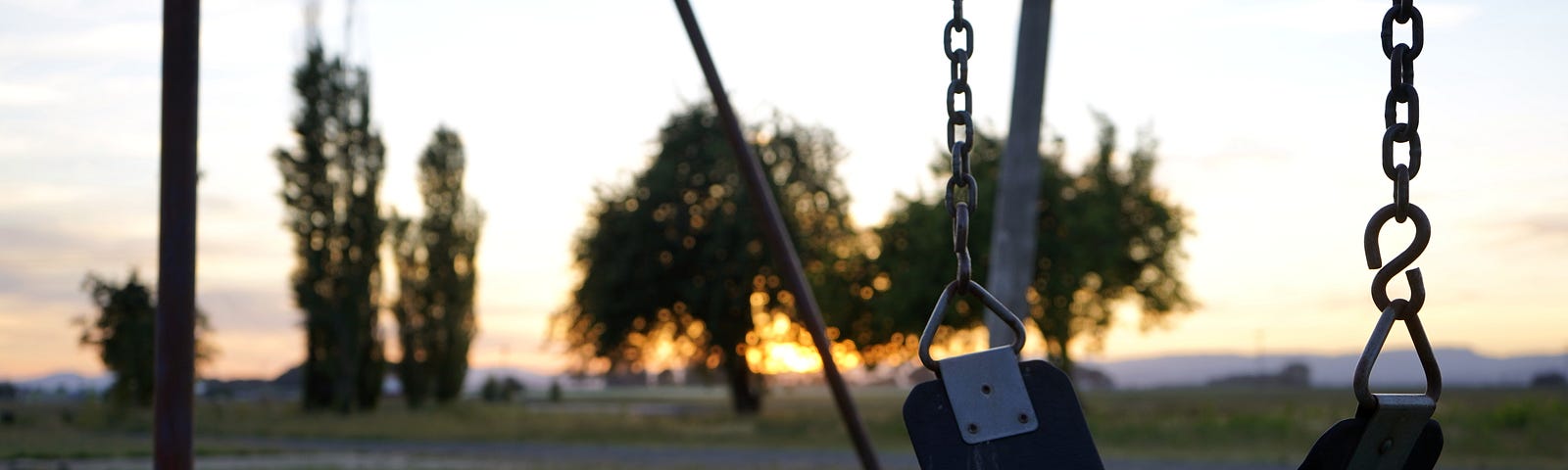 An empty swing in a children’s playground.