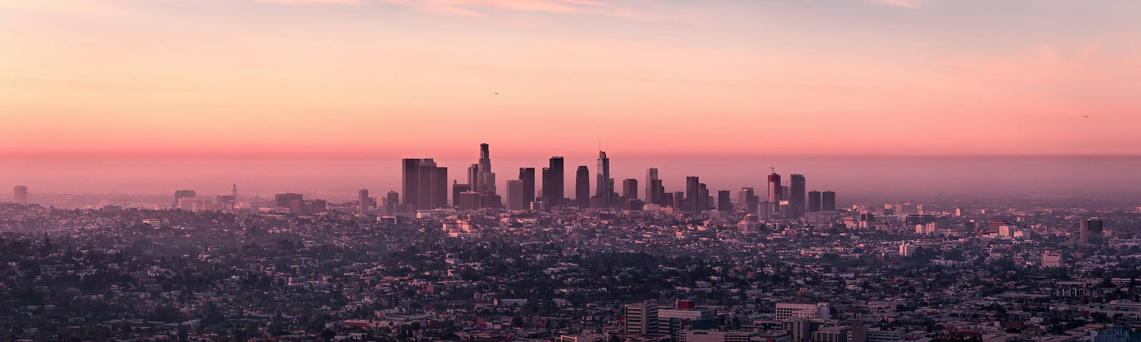 The Los Angeles city skyline at sunset.