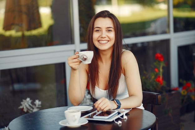 Young female writer having a coffee outdoors
