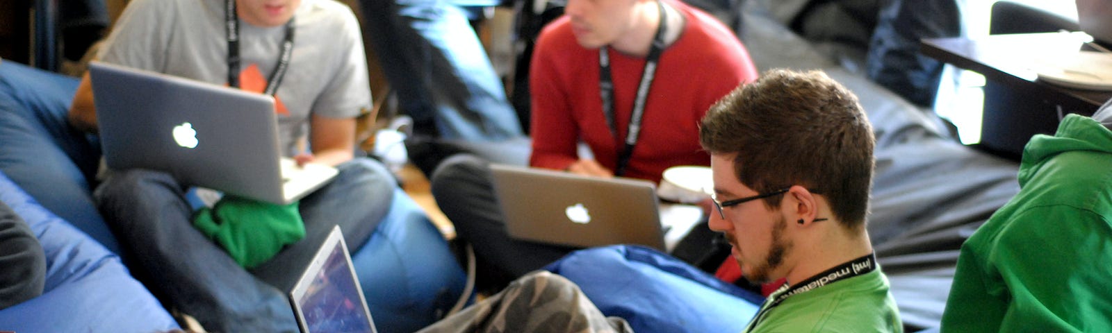 pic of 3 young men working on their laptops and networking together