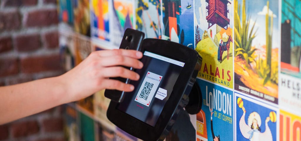 someone using a smartphone to scan a QR code