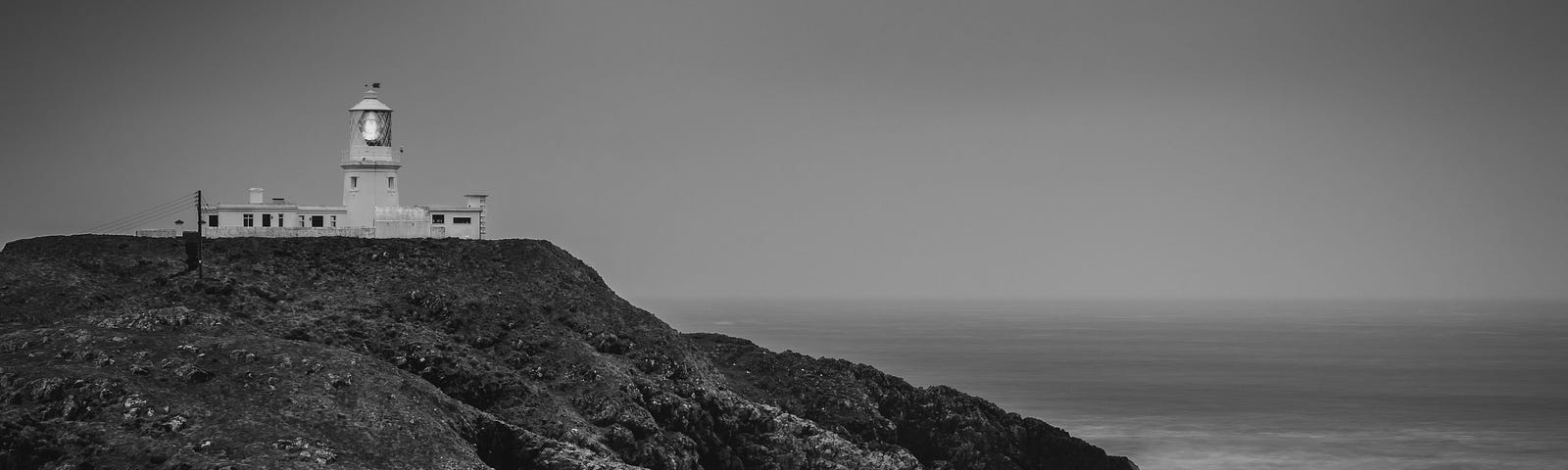 Lighthouse in Wales on the cliffs looking out to sea