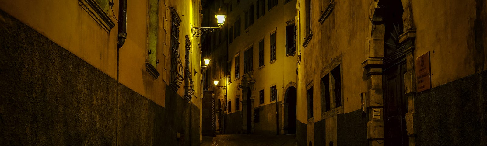 A dimly lit alley in an old European town.