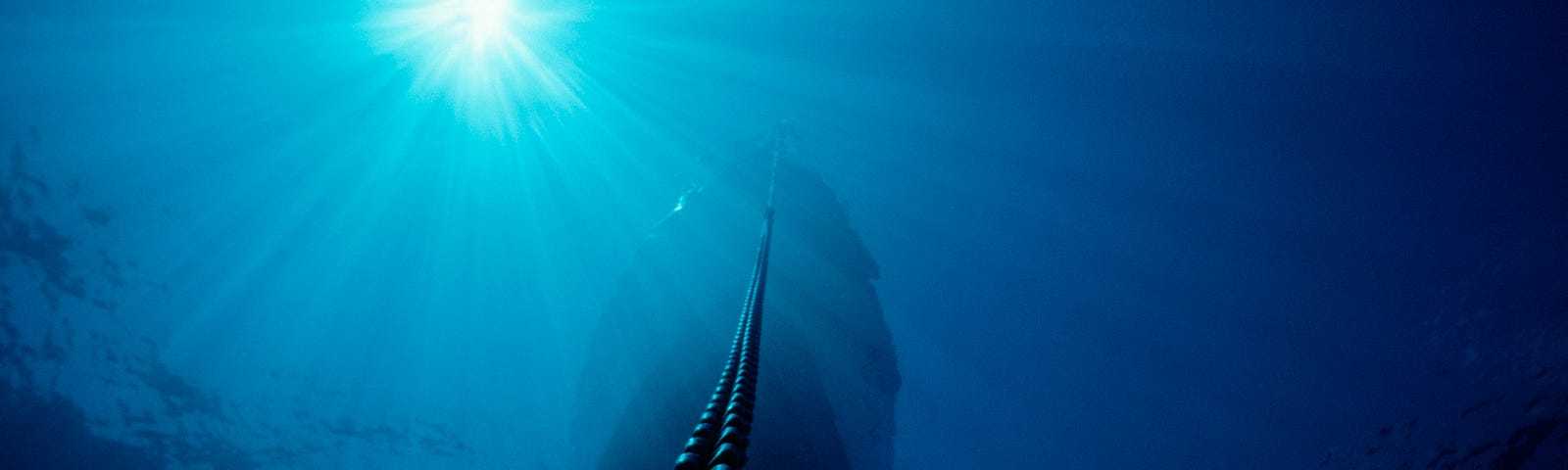 Underwater Anchor chain hanging from a boat