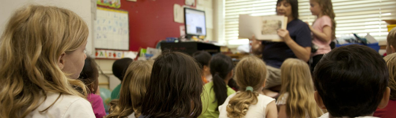 Kids in school listening to a teacher