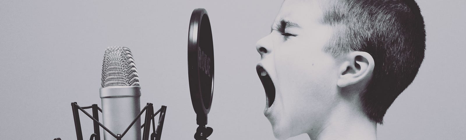 Boy screaming into a microphone