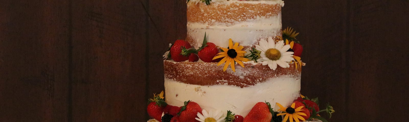 A 3-layer cake with flowers on top.