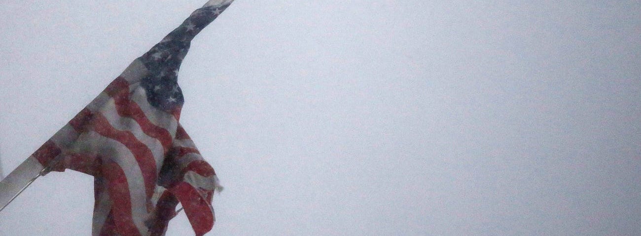 An American Flag flies in blizzard-like conditions on January 23, 2016 in the Brooklyn borough of New York City.