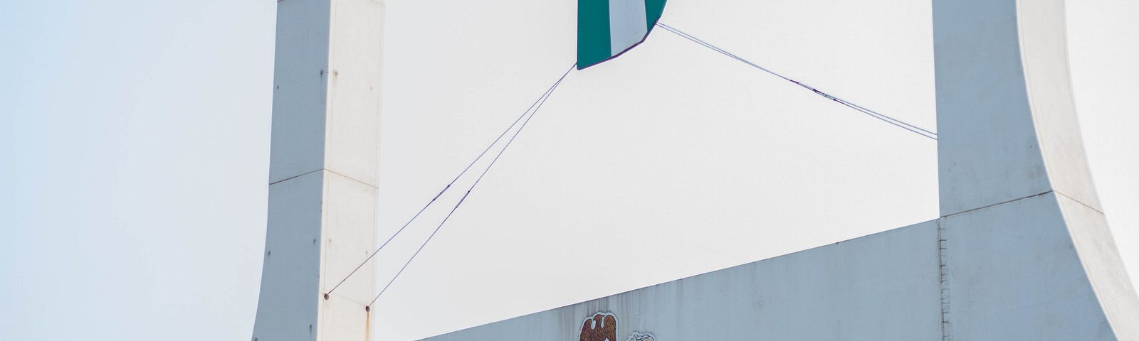 A welcome sign with the Nigerian flag and coat of arms