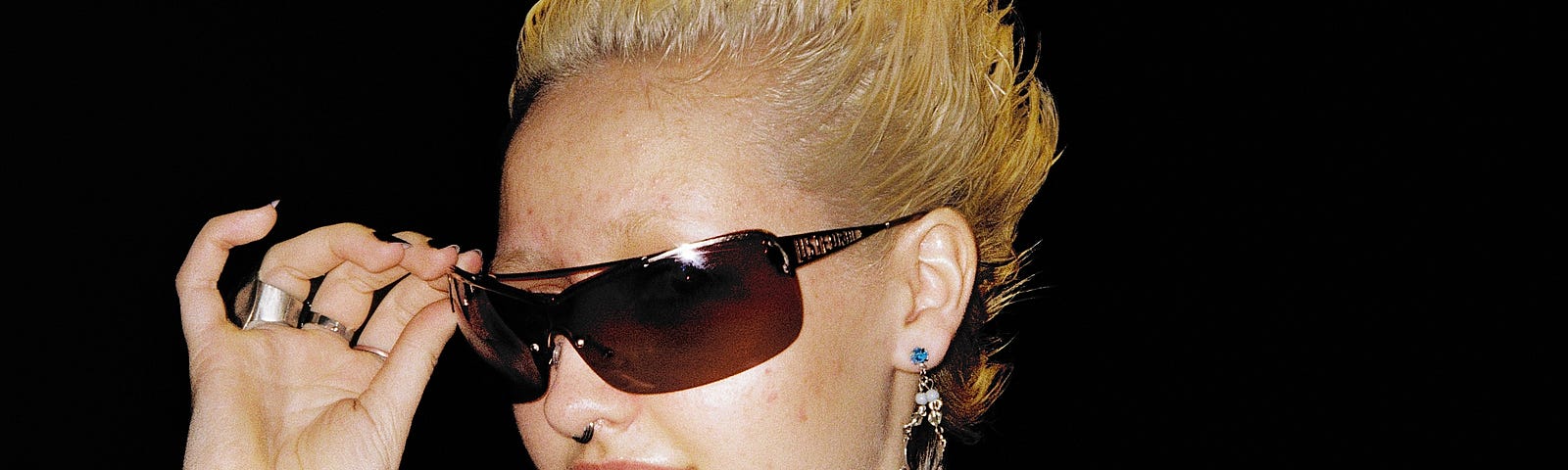headshot of a woman with blonde hair and sunglasses