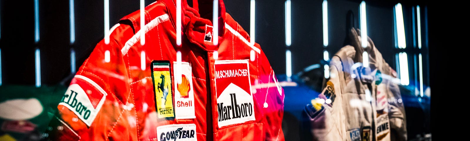 Bright red Ferrari F1 gear, which was worn by Michael Schumacher.