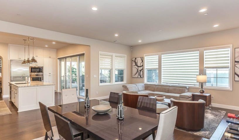 Living room with hardwood flooring, wooden furniture and recessed lighting