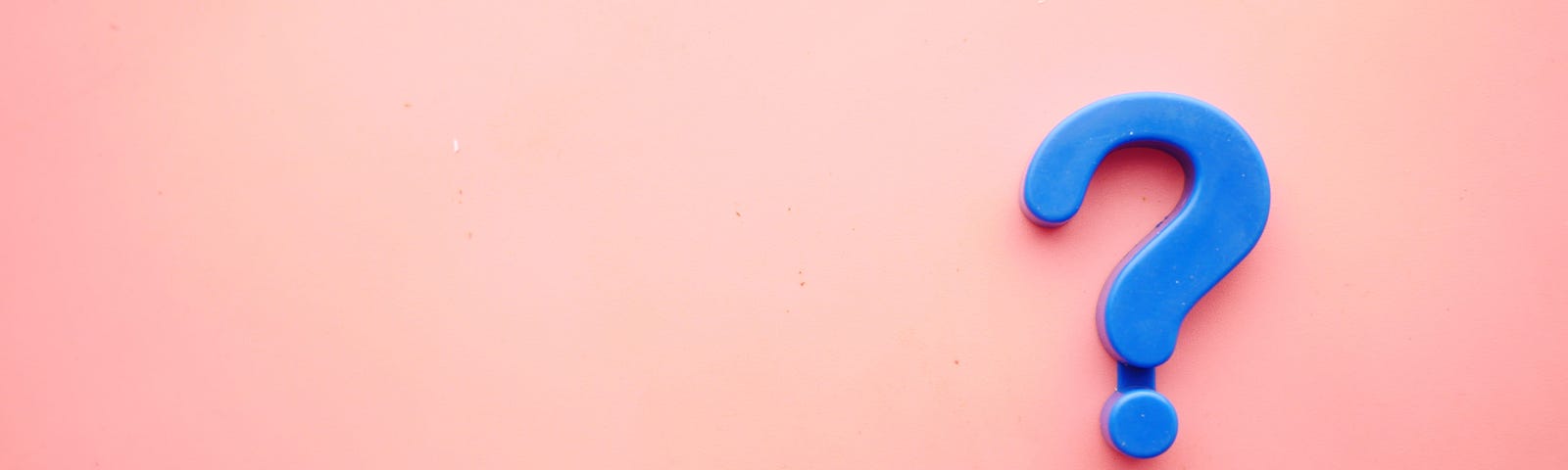 Blue question mark on pink background