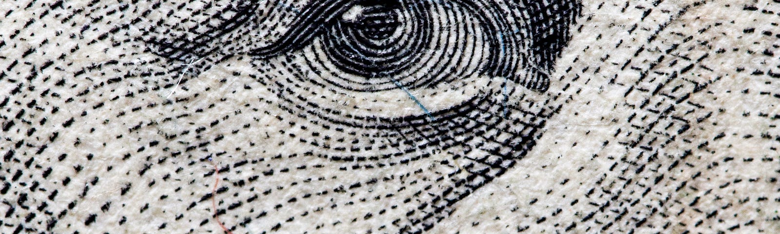 Close-up of George Washington’s eye on the U.S. one dollar bill