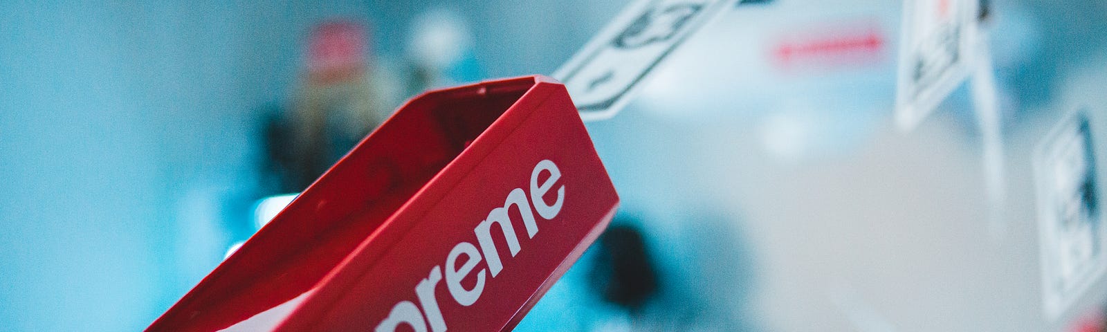 A photo of a gun-like device shooting money, branded by Supreme