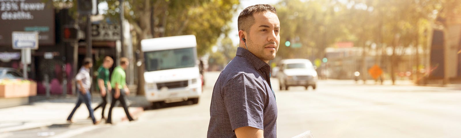 A Guy crossing the road in lost in thoughts, probably looking for a job