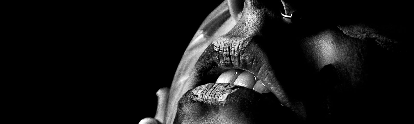 Black and white photo of a very sensual woman’s mouth.