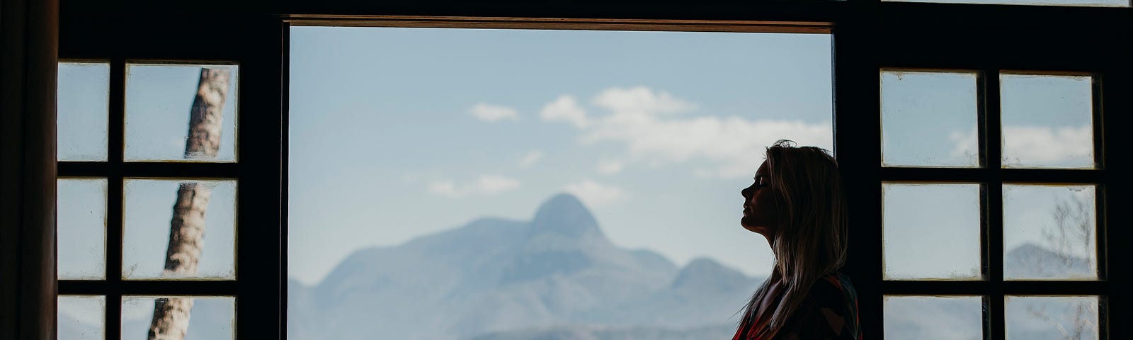 Here is a picture of a young woman overlooking a mountain view, reflecting on her spiritual life and relationship with God.