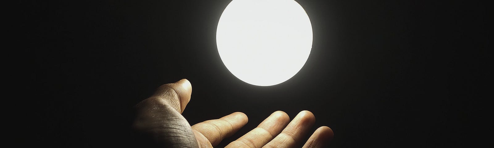 Hand holding the moon