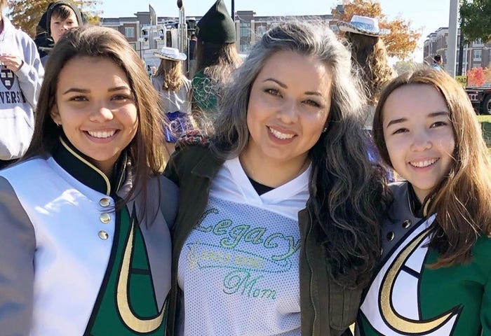 Vanessa Corral and her two daughters in their marching band uniforms in Frisco, Texas.