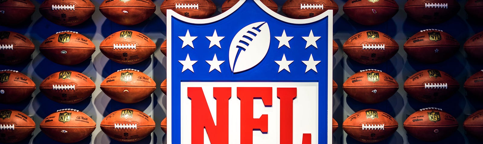 Week 10 NFL update in 100 words feature image, NFL banner surrounded by footballs.