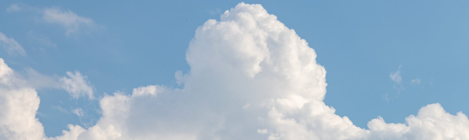 White billowy clouds floating in the blue sky