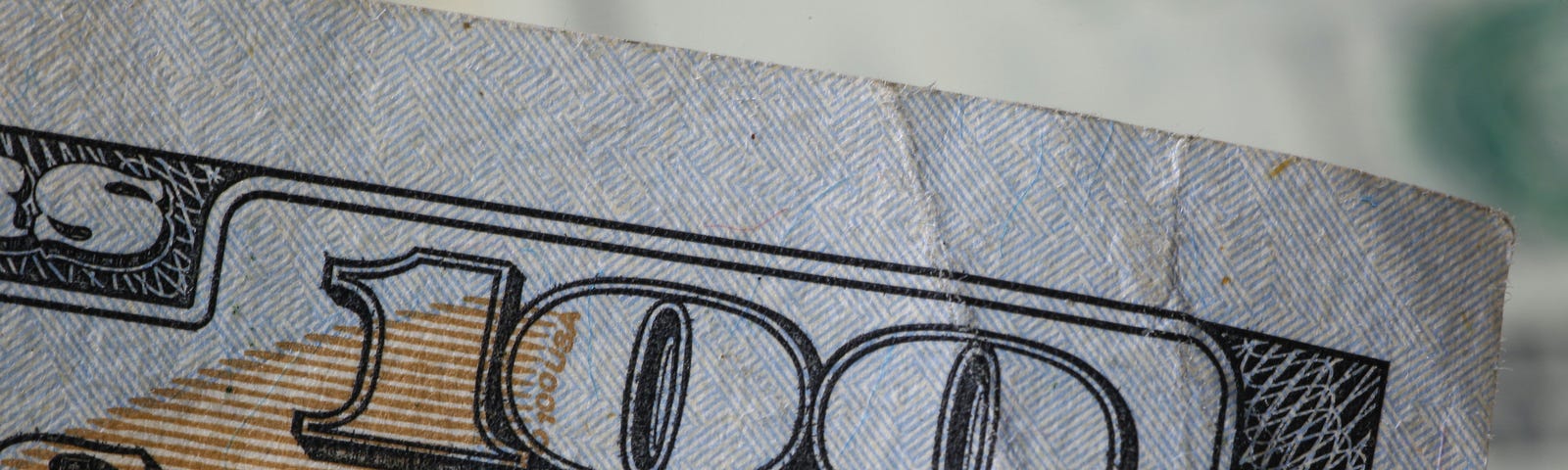 Close up of 100 on a banknote