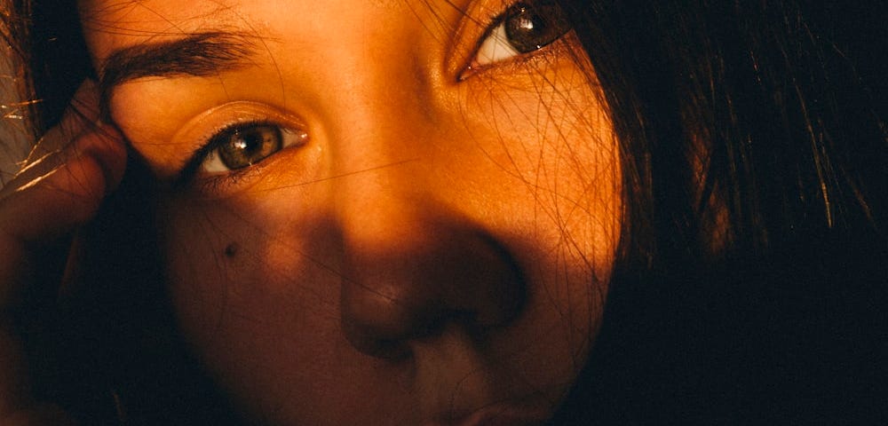 A close-up of a woman talking on a cell phone.