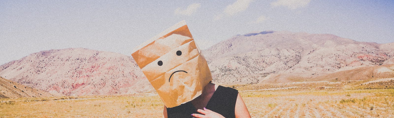 Man in the desert with a paper bag over his head