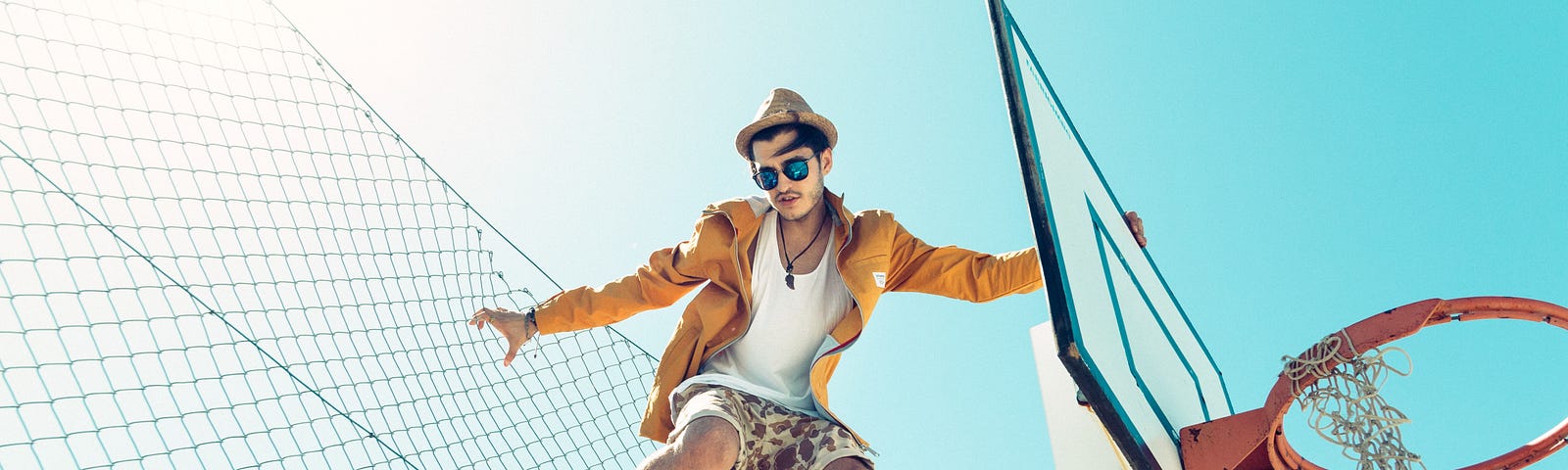 A cool man jumping on the basketball court