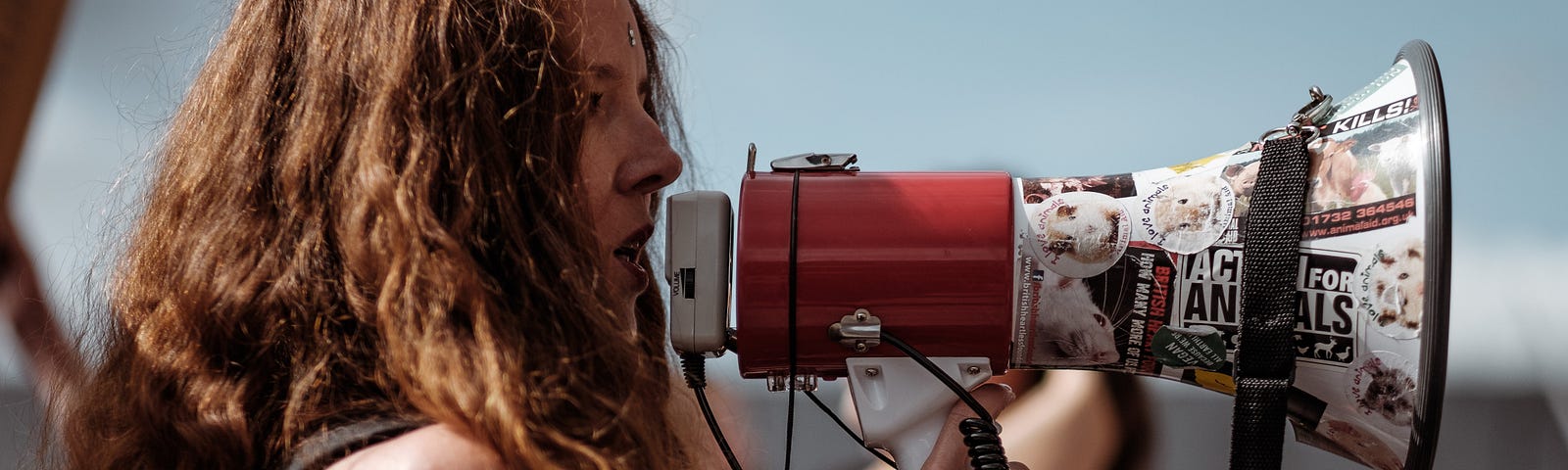 Girl with long hair using a megaphone